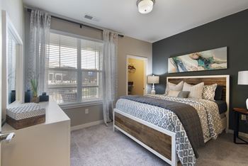a bedroom with a bed and a window  at Watermark at Harvest Junction, Longmont